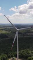 A wind turbine is shown in the sky video