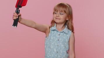 Child girl kid blogger taking selfie on smartphone communicating call online with subscribers video