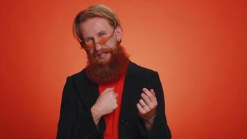 Man showing a little bit gesture with sceptic smile, showing minimum sign, measuring small size video