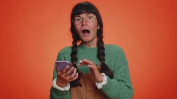 Happy excited woman use mobile phone say wow yes found out great big win news doing winner gesture video