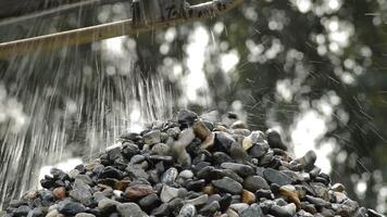 Pebbles and water falling in a stones mountain in a sand quarry video