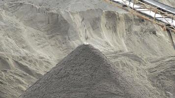 Sand falling in a sand mountain by a conveyor in a sand and pebbles quarry video