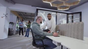A diverse group of colleagues collaboratively and efficiently tackles various business tasks in a modern office, exemplifying teamwork, productivity, and a dynamic corporate environment. video