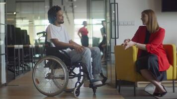 African American businessman in a wheelchair engages in a professional discussion with his colleague, addressing various business challenges and exploring solutions in an inclusive and diverse modern video