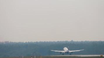 Rear view of jet passenger plane with unrecognizable livery accelerating and taking off video