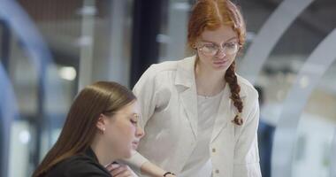 Modern businesswomens using hand gestures to explain business tasks to their colleagues, showcasing effective communication, collaboration, and problem-solving in a contemporary corporate setting video