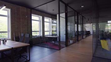 Modern startup centers composed of glass offices within a contemporary corporate environment, highlighting the sleek, innovative, and minimalist design aesthetics of a cutting-edge workspace video