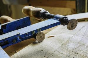 Carpenter's clamps in the carpentry workshop photo
