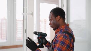 African american windows installation worker in uniform with screwdriver video