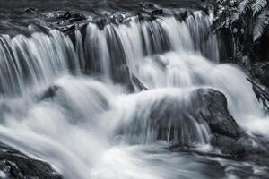 A black and white photo of a waterfall
