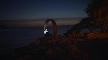A Serene and Beautiful Coastal Scene at Dusk Featuring a Unique Artistic Installation video