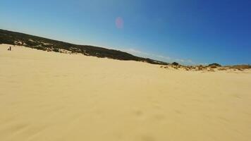 Sand dunes in the desert during the day, drone video