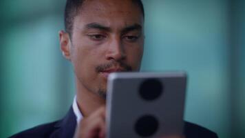 A Focused and Dedicated Professional Utilizing a Tablet in a Modern Work Environment video