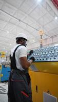 Worker On Factory Analyzes The Production Process And Programming Industrial CNC Machine Tool. Vertical video