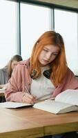 Exams. Students writing a test in their exercise books. Vertical video