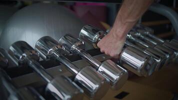 A CloseUp View of Shiny Metallic Dumbbells in a Contemporary and Modern Gym Setting video