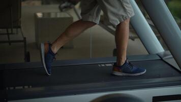 A Person Engaging in Walking on a Treadmill in a Gym Setting for Physical Fitness and Health video