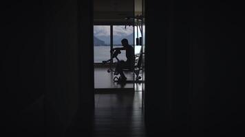 A cyclists silhouette is seen in a beautifully lit indoor space filled with design video