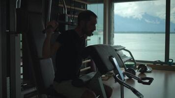 A man engaging in a workout routine at a modern gym that offers a stunning scenic view video