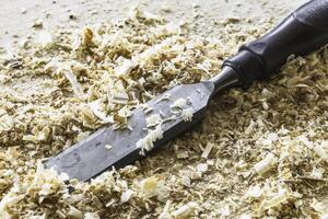 Chisel lying in wood shavings photo