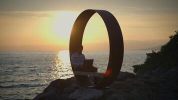Experience the Serene Sunset Embrace Remote Work by the Ocean in a Modern Design Setting video