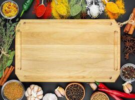 A variety of spices and herbs on a dark table. Cooking background. View from above. Ingredients for cooking. Table background menu. Copy space. photo