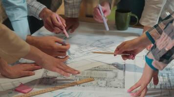 Office team coworking group unrecognizable business men women brainstorm designers engineers architects constructors discussion architecture project building plan construction blueprint chart on table video