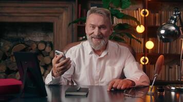 Old Caucasian man businessman looking at camera mobile phone smartphone showing green screen display technology internet social network web cyberspace connection e-commerce freelance e-business elder video