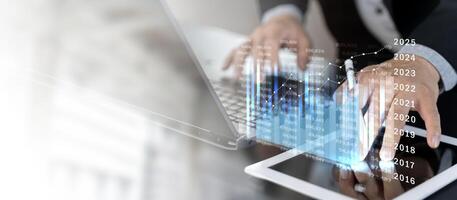 Businessman using digital tablet analyzing sales data and economic growth graph chart photo