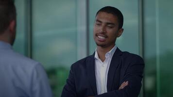 A confident young businessman engaging in a thorough and productive discussion with peers video