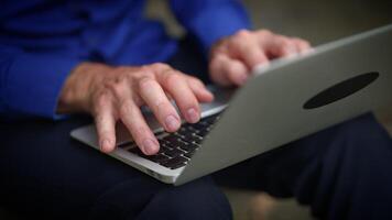 Focused hands diligently typing on a laptop while in a modern and dynamic environment video