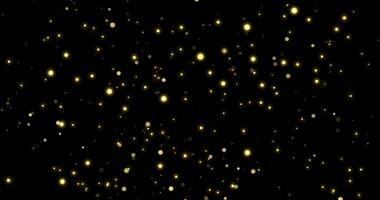 Gold bokeh on particles floating in the air. Dust and glitter particles background. Black background , Use blending mode screen video