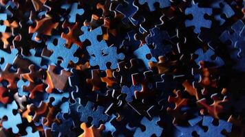 Background of Colored Puzzle Pieces that Rotating Counterclockwise - Top View. Texture of Incomplete Red and Blue Jigsaw Puzzle with Low Key Light - Left Rotation video