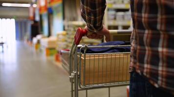 A man pushing trolley in hardware store video