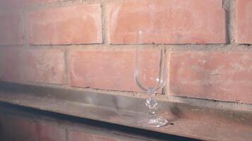 Firecracker Exploaded in a Wineglass Against a Brick Wall. The Blast Wave of a Petard Damaged the Glass and Many Small Fragments of Glass Flew in Different Directions - Static Shot video