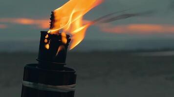 Tropical Bamboo Torch Burning in the Beach at Summer Evening. Decorative Candle Has a Massive Orange Flame Using Oil Fuel or Kerosene - Slow Motion. CloseUp Static Shot video