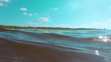 Over and Under Sea Surface with the Lights of the Sun Through the Water. Underwater Split View with Sea Waves at Sunny Summer Day - Slow Motion video