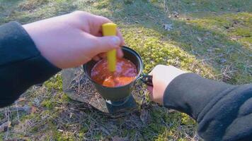Camp Food. Cooking in a Hike Using a Small Cook Set - First Person View, Wide Angle. Food on the Trip. Traveler in a Spring Forest. Tourist in a Travel is Heating Food - POV Shot. video