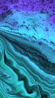 Slowly liquid texture of paint. Stock footage. Beautiful patterned streams of liquid paint move on black background. Artistic background with slowly changing pattern of colors video