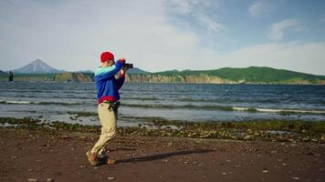 Man Admiring Beauty Of Nature Of Oceanic Shore In Northern Islands In Summertime, Taking Photos video