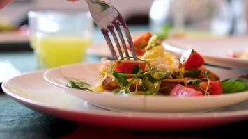 microgreens with a fork and poached egg Benedict. Egg benedict with hollandaise sauce and smoked salmon on toast video