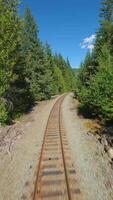 FPV drone is flying fast forward over railway track. Canada video