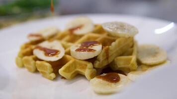 Pour caramel onto waffles pouring honey or maple syrup onto Belgian waffles. video
