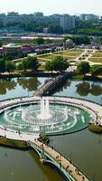 Top view of fountain in pond and historical palace. Creative. Amazing fountain in lake with pedestrian bridges at historical palace. Historical complex with fountains, gardens and buildings video