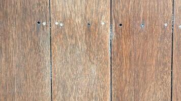 wood texture with natural grains and screw holes. The aged wooden planks feature a rustic appearance, perfect for backgrounds, construction projects photo