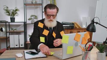 Tired sad exhausted businessman working on laptop at office with many sticker tasks, panic attack video