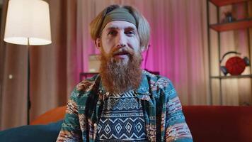 POV of redhead man at home looking at camera, making webcam conference call conversation video