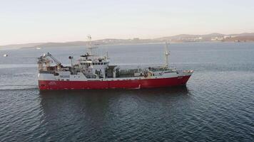 View from the drone vertically down on a fishing trawler at sea on the move video