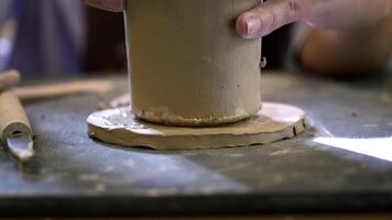 An Artisan is Engaged in the Creative Process of Forming Clay Pottery on a Work Surface. Stock Clip video
