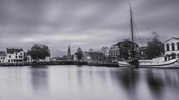 Delft, The Netherlands October 15, 2024. The harbour of Delft, with some old boats, and the skyline from the city. photo
